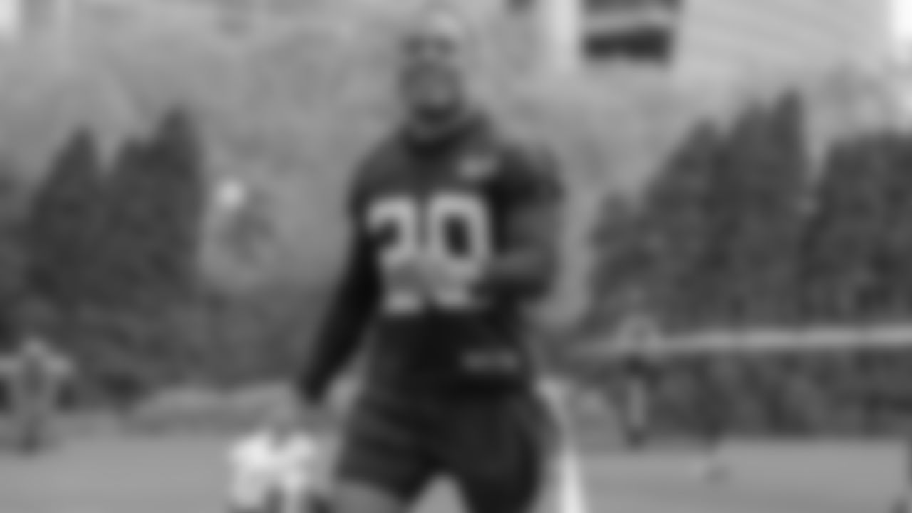 KeiVarae Russell walks onto the field smiling at the team's voluntary minicamp.