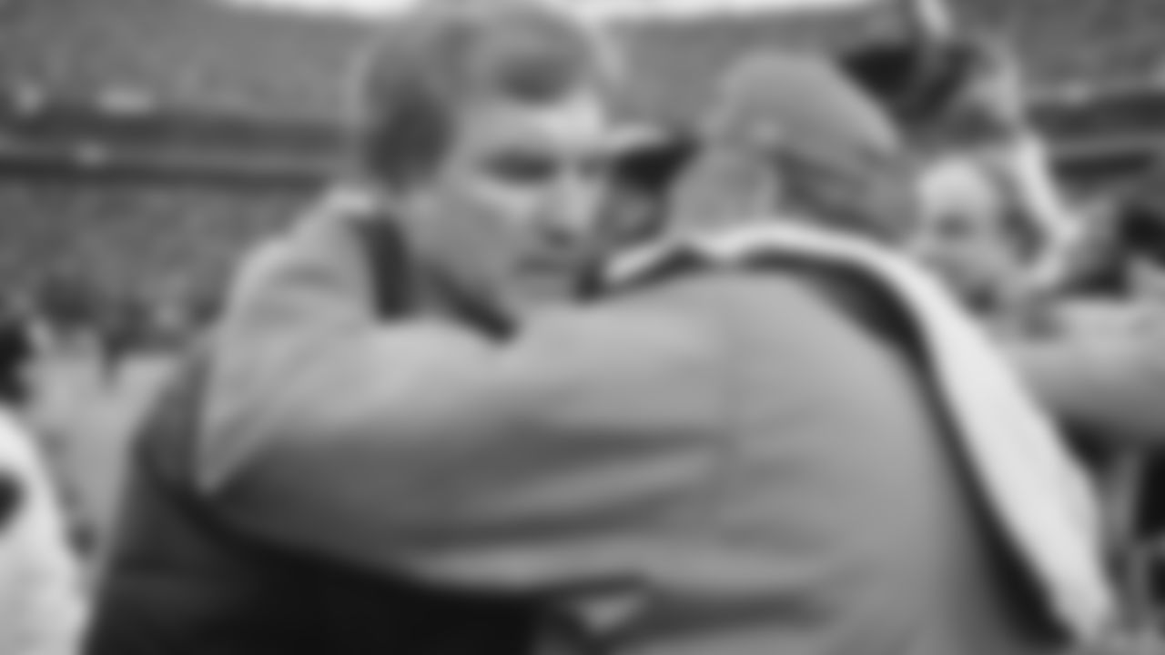 Cincinnati Bengals head coach Forrest Gregg, left, is embraced by Buffalo Bills head coach Chuck Knox as they meet on the field after the Bengals beat the Bills in an AFC Playoff game, Sunday, Jan. 3, 1982, Cincinnati, Oh. (AP Photo)