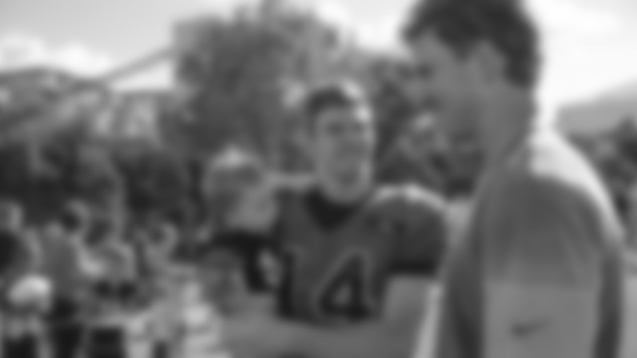 Cincinnati Bengals quarterback Andy Dalton, center, meets with New York Giants quarterback Eli Manning, right, after a joint NFL football training camp, Wednesday, Aug. 12, 2015, in Cincinnati. (AP Photo/John Minchillo)