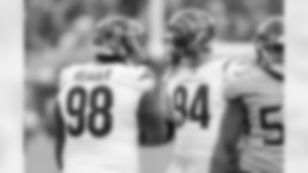 DT DJ Dearer (left) and DE Sam Hubbard fist bump during the first quarter of the Bengals-Titans game on Sunday, November 27 in Week 12 of the 2022 season.