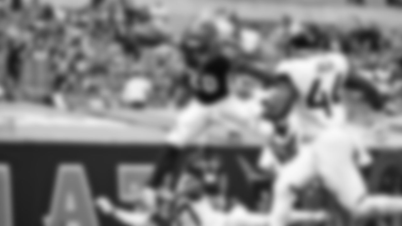 Running back Joe Mixon leaps high over a defender to score a touchdown against the Jacksonville Jaguars in Week 4 of the 2020 NFL season.