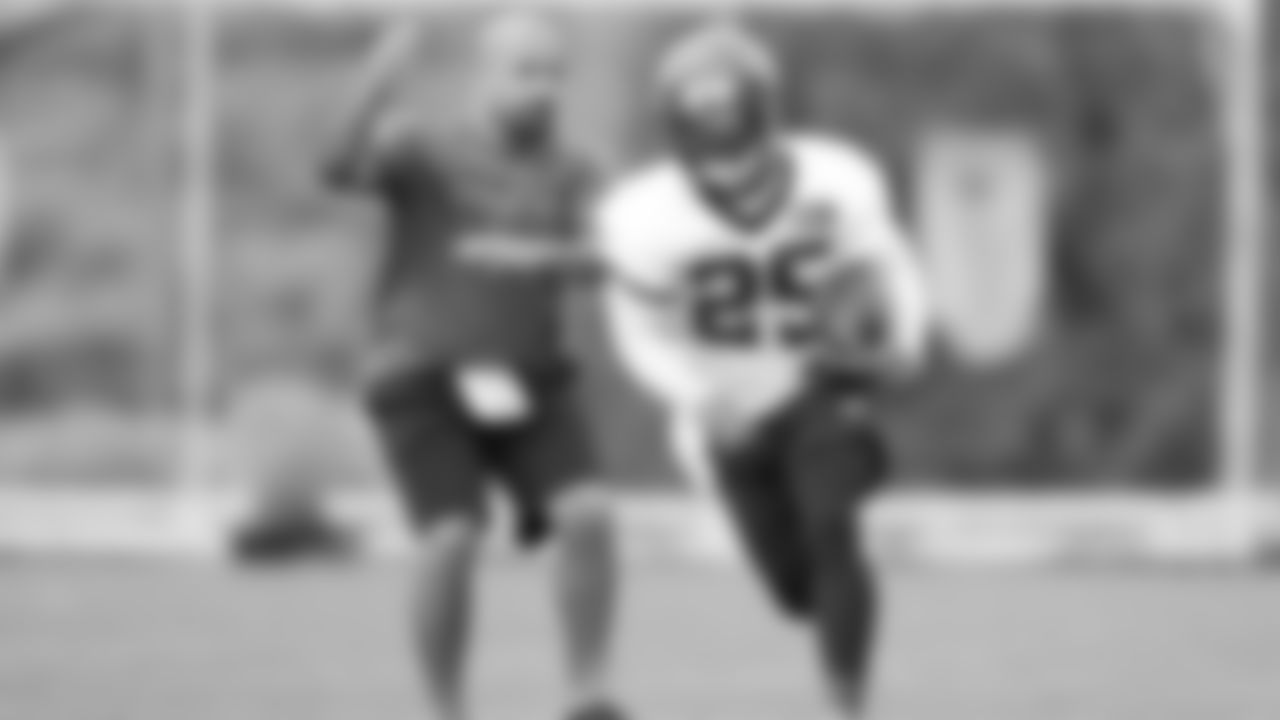 Bengals running back coach Jemal Singleton works with Giovani Bernard during day one of the team's voluntary minicamp.
