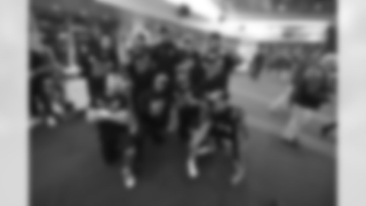 Bengals HB and WR pose for a photo as the team celebrates winning the AFC North in the Bengals locker room at Paycor Stadium on Sunday, January 8 2023.