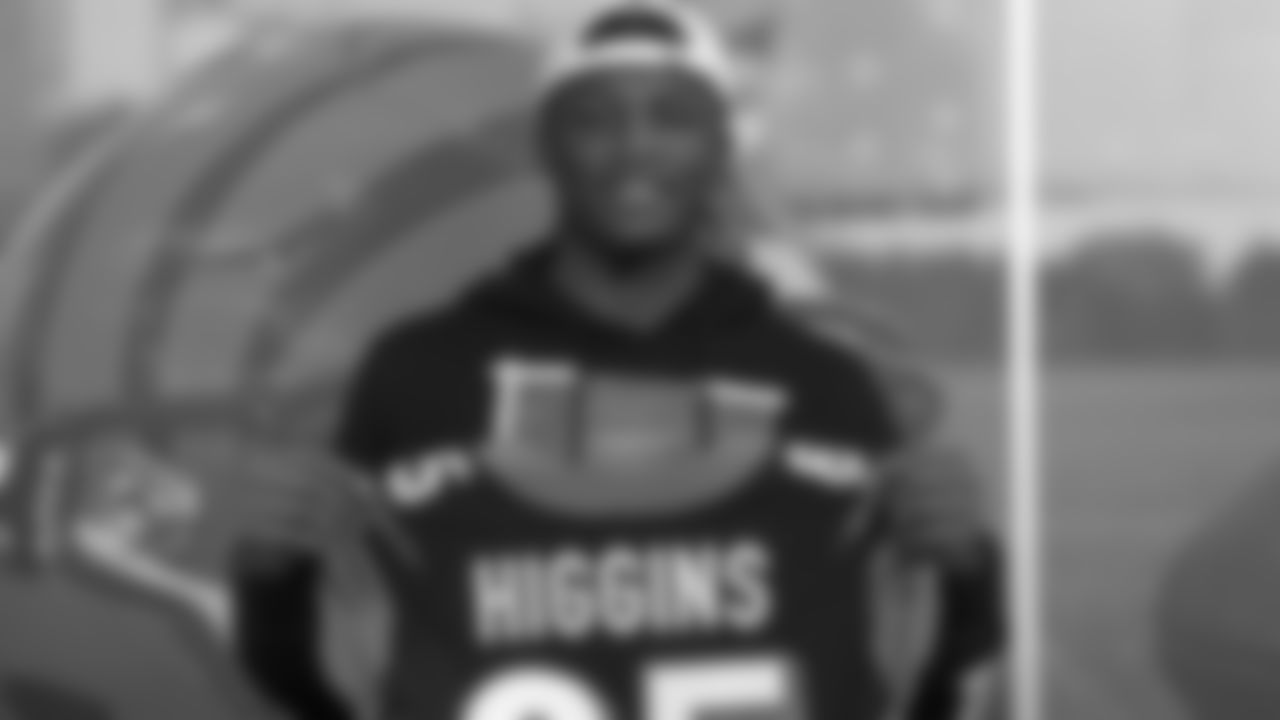 Bengals wide receiver Tee Higgins holds up his jersey after signing his first NFL contract at Paul Brown Stadium.