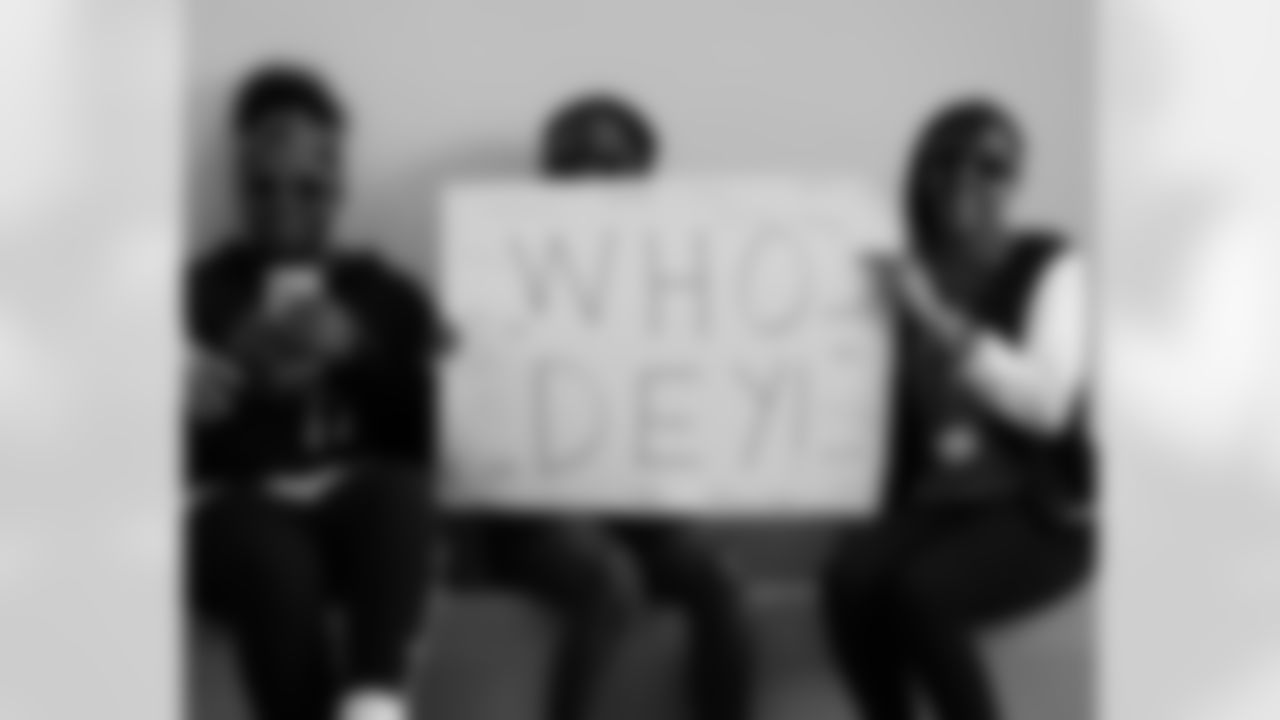 Students pose with a sign that says "Who Dey" with student's signatures on it during the Rule Your School pep rally at Woodlawn Elementary in Cincinnati, Ohio.