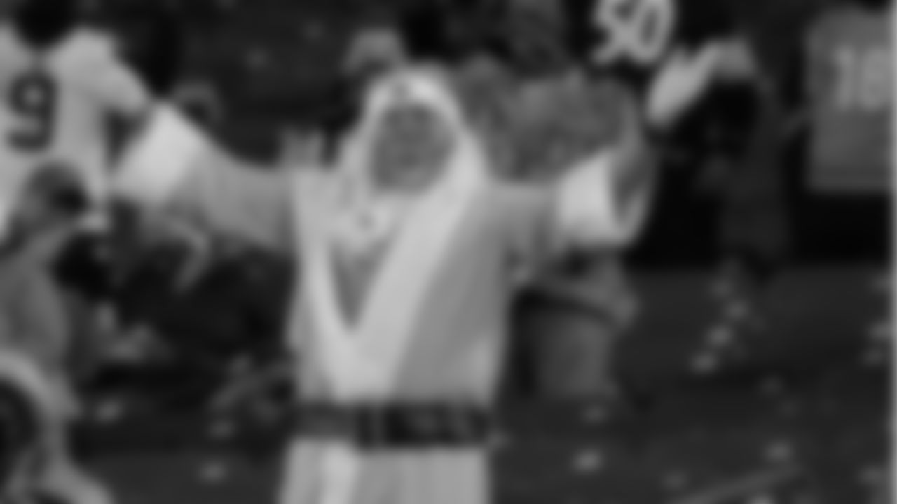 A fan dressed in a Santa hat and bath robe cheers on the Bengals during the Monday Night Football game against the Steelers at Paul Brown Stadium on Monday, Dec. 21, 2020.