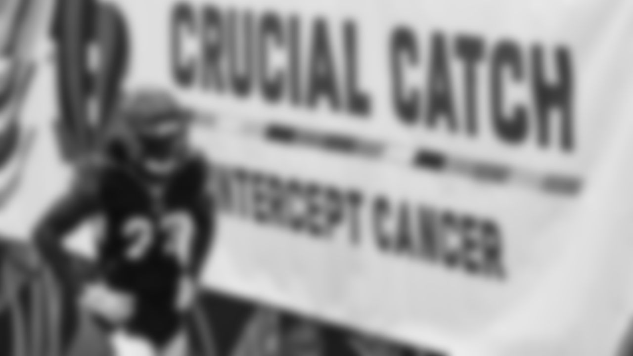 Cincinnati Bengals' Tony Brown (27) walks past a "Crucial Catch" banner before an NFL football game against the Cleveland Browns, Sunday, Oct. 25, 2020, in Cincinnati. (AP Photo/Bryan Woolston)
