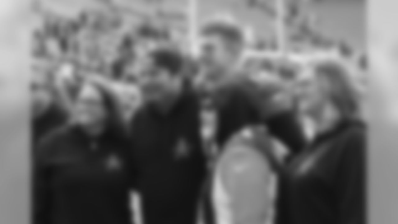 Andy Dalton takes pictures with fans on the field before the week 12 matchup against the Browns.