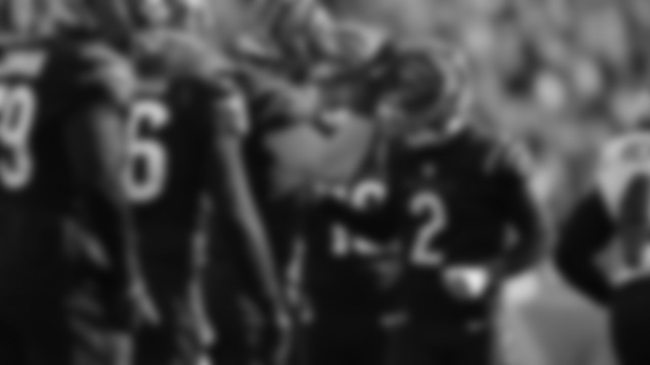 Kicker Evan McPherson is greeted by teammates after he converted a 30-yard field goal against the Baltimore Ravens.