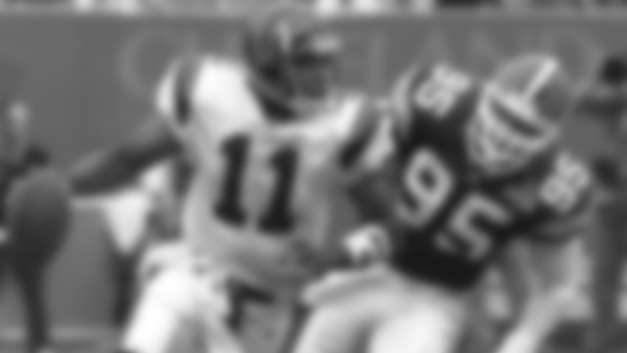 Cleveland Browns linebacker Jamir Miller (95) chases Cincinnati Bengals quarterback Akili Smith (11) during a game Sunday, Oct. 10, 1999 in Cleveland. (AP Photo/Tony Dejak)