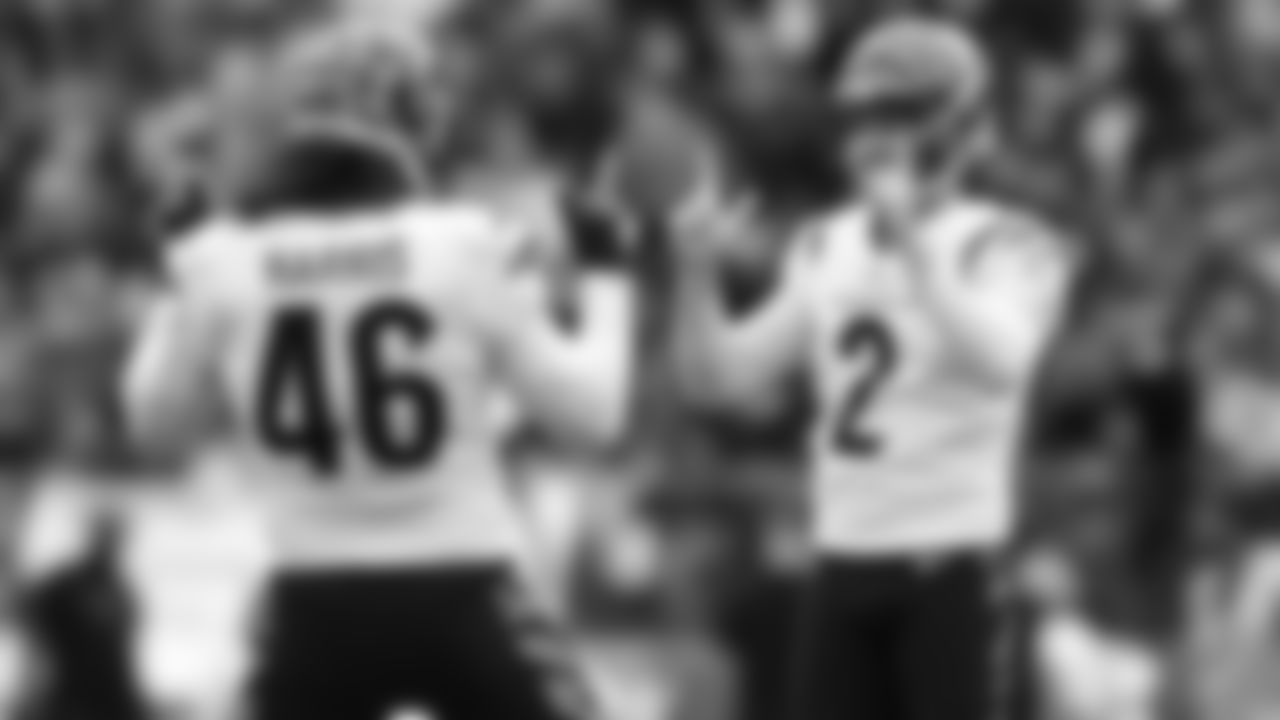 Clark Harris and Evan McPherson celebrate after converting a 52-yard field goal in the first quarter against the Baltimore Ravens.