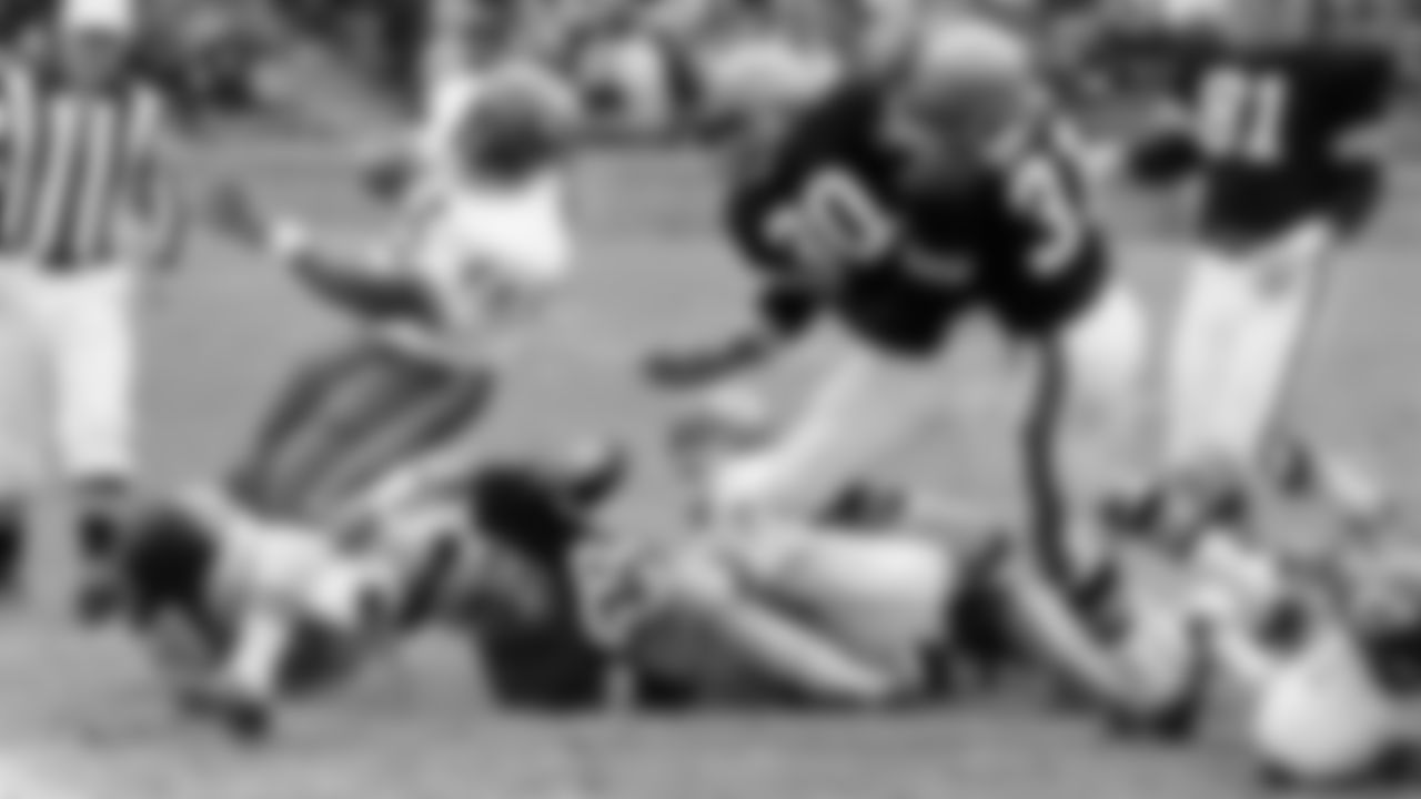 Bengals defender Jim Griffin makes a tackle against the Kansas City Chiefs in an AFL game in Cincinnati, Ohio, Nov. 10, 1968. Bengals are; Jim Griffin (76) and Al Beauchamp (58) on the ground and Jess Phillips (30) and Fletcher Smith (31).