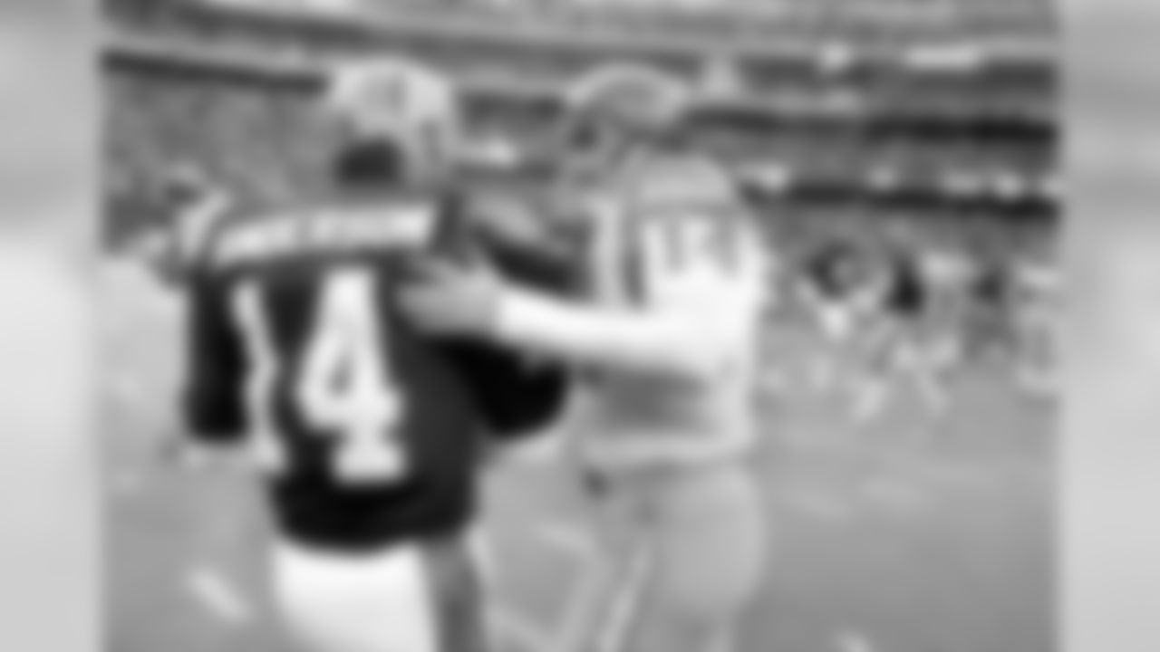 Cincinnati Bengals quarterback Ken Anderson, left, reacts as San Diego Chargers quarterback Dan Fouts, right, looks dejected after the Bengals defeated the Chargers in the AFC championship in Cincinnati on Jan. 10, 1982. Fouts was intercepted twice in the game, and Anderson passed for two touchdowns and no interceptions. (AP Photo)