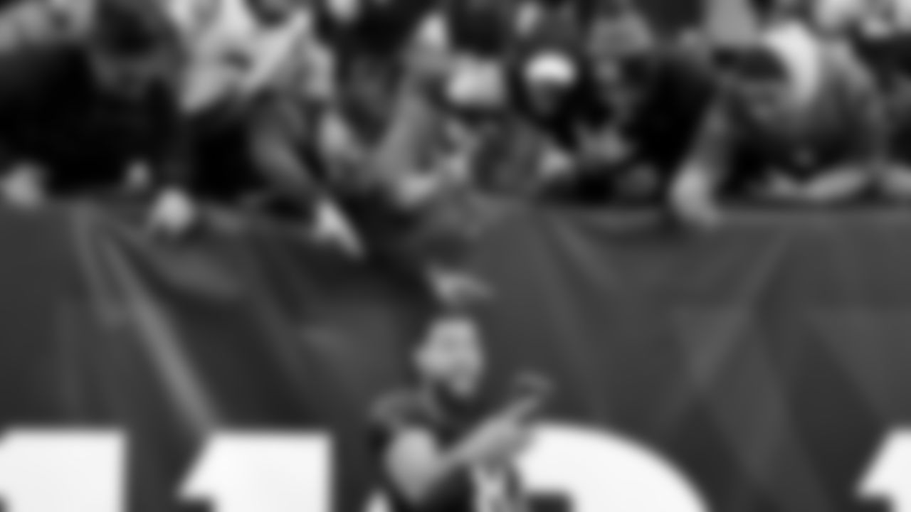 Cincinnati Bengals tight end C.J. Uzomah (87) takes a photo with fans after a 41-21 win over the Baltimore Ravens after an NFL football game, Sunday, Dec. 26, 2021, in Cincinnati. (AP Photo/Emilee Chinn)