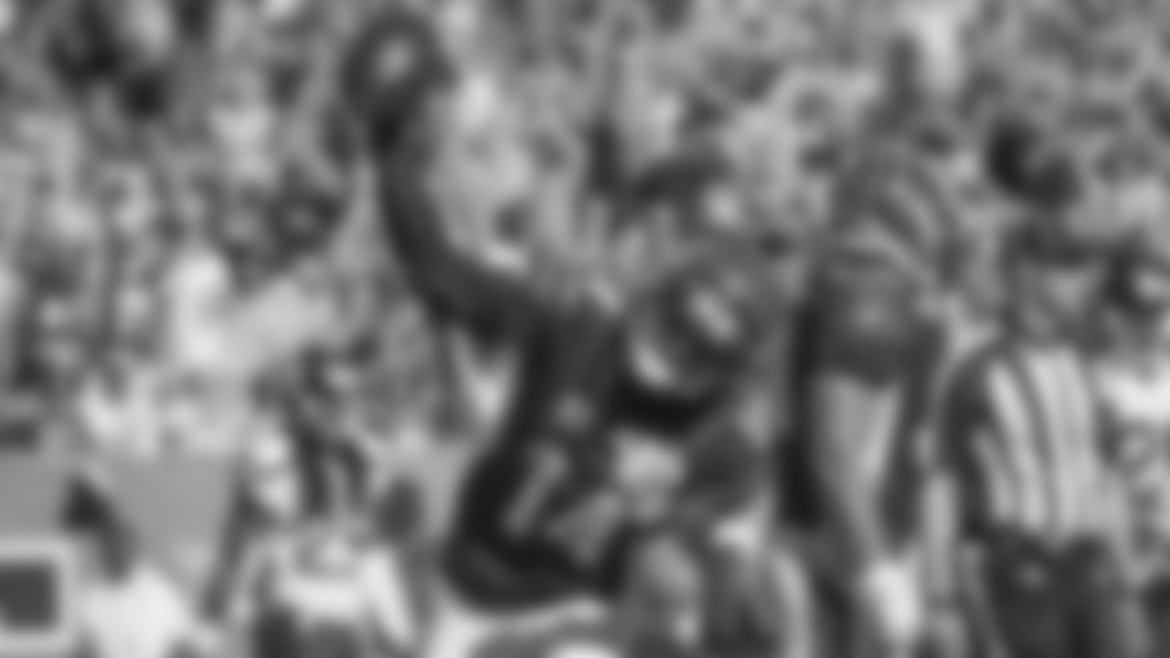 FILE - In this Oct. 11, 2015, file photo, Cincinnati Bengals quarterback Andy Dalton (14) celebrates after scoring a touchdown in the second half of an NFL football game against the Seattle Seahawks in Cincinnati. Dalton got booed in Cincinnati over the summer when he was introduced before an All-Star celebrity softball game. He doesn't hear boos anymore, not with the Bengals (5-0) unbeaten. (AP Photo/Frank Victores, File)