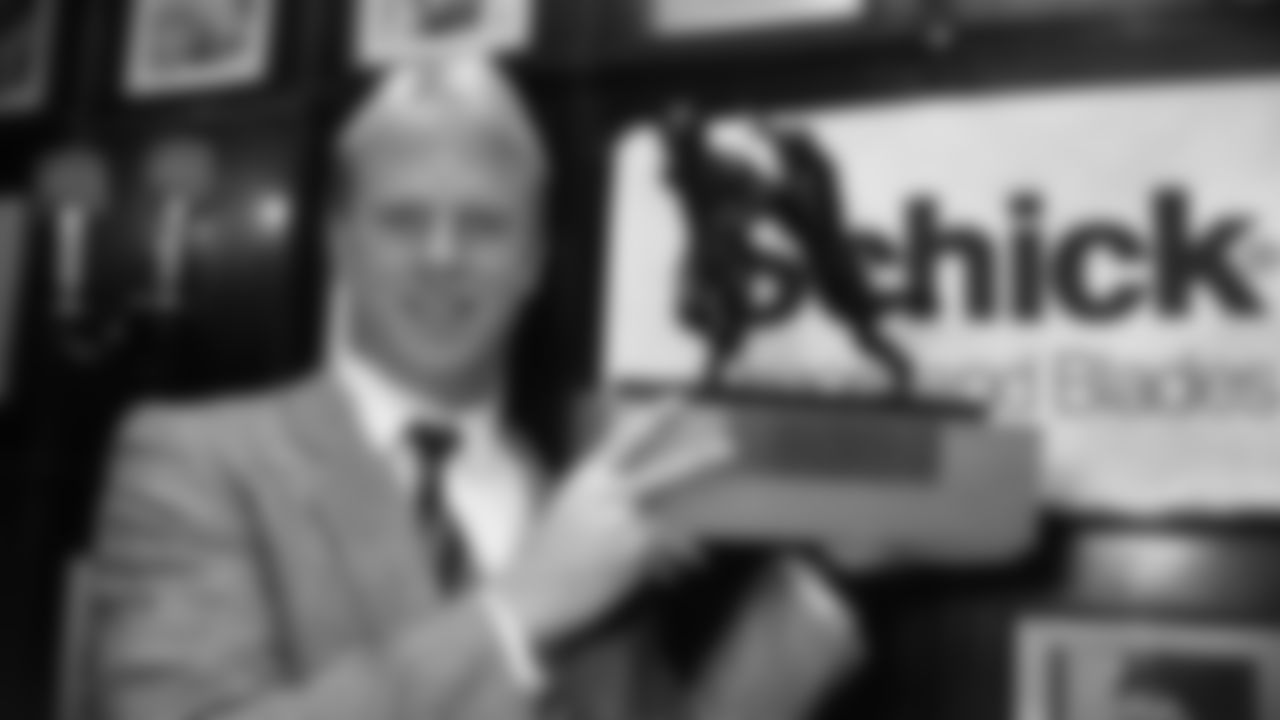 Cincinnati Bengals quarterback Boomer Esiason holds the Schick Trophy as the NFL's Most Valuable Player for the 1988 season.