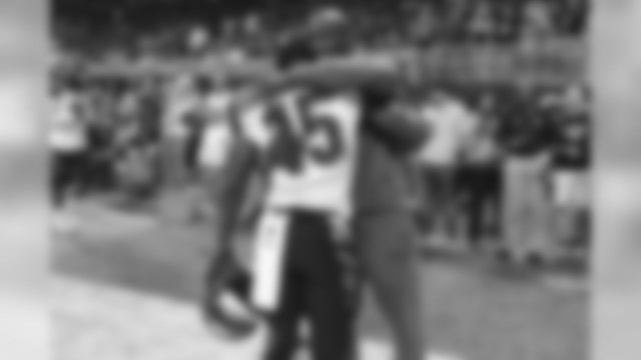 Former Cincinnati Bengals wide receiver Chad Johnson hugs Cincinnati Bengals wide receiver John Ross (15) prior to a game against the Atlanta Falcons, Sunday, Sept. 30, 2018 in Atlanta. Cincinnati won 37-36. (Logan Bowles via AP)