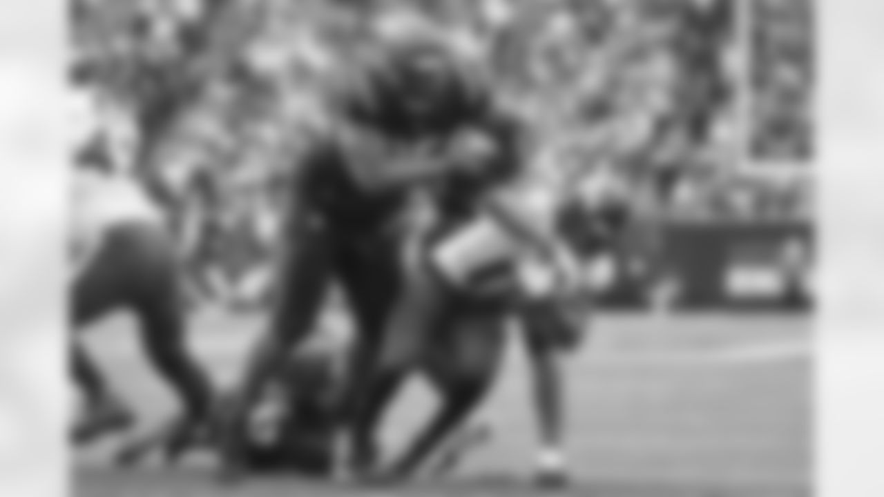 DT Zach Carter and other Bengals defense takes down the Baltimore ballcarrier during the third quarter of Week 18 against the Baltimore Ravens at Paycor Stadium in Cincinnati, Ohio on Sunday, January 8 2023.
