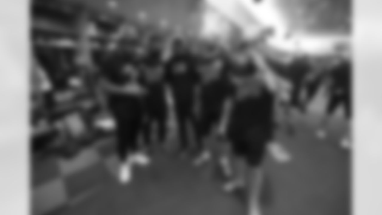 Bengals halfbacks pose for a photo as the team celebrates winning the AFC North in the Bengals locker room at Paycor Stadium on Sunday, January 8 2023.