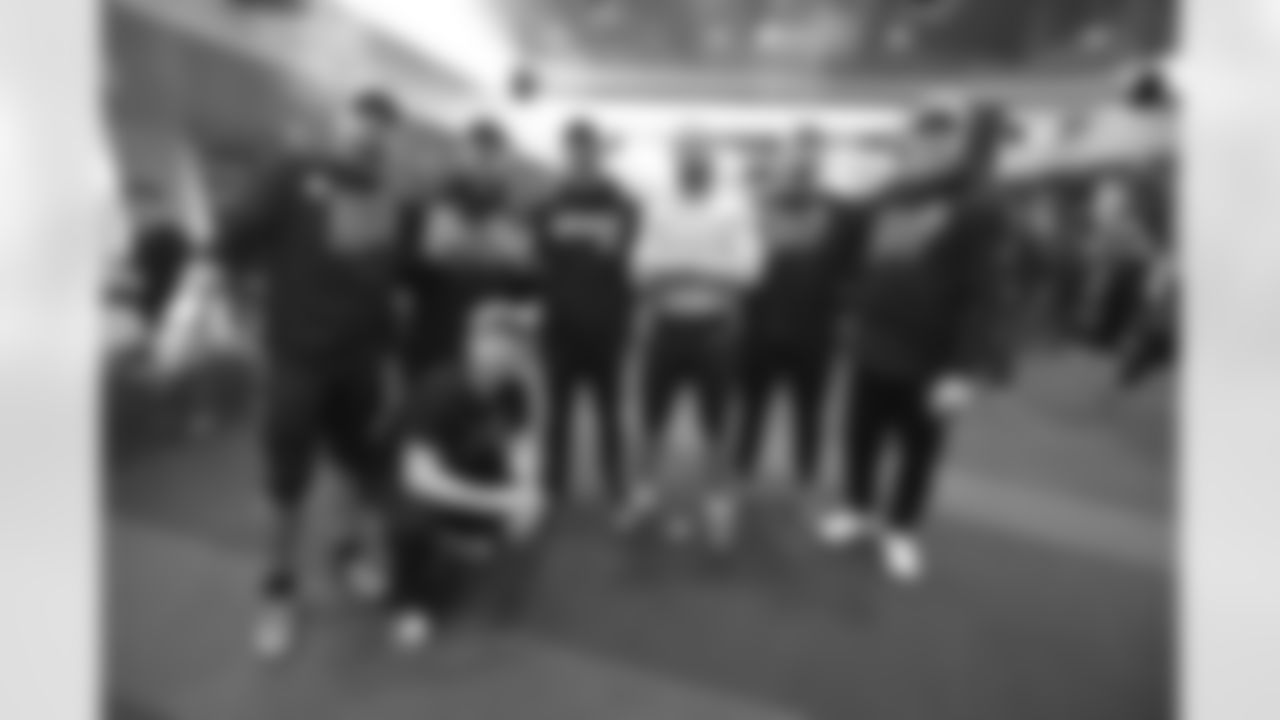 Bengals tight ends pose for a photo as the team celebrates winning the AFC North in the Bengals locker room at Paycor Stadium on Sunday, January 8 2023.