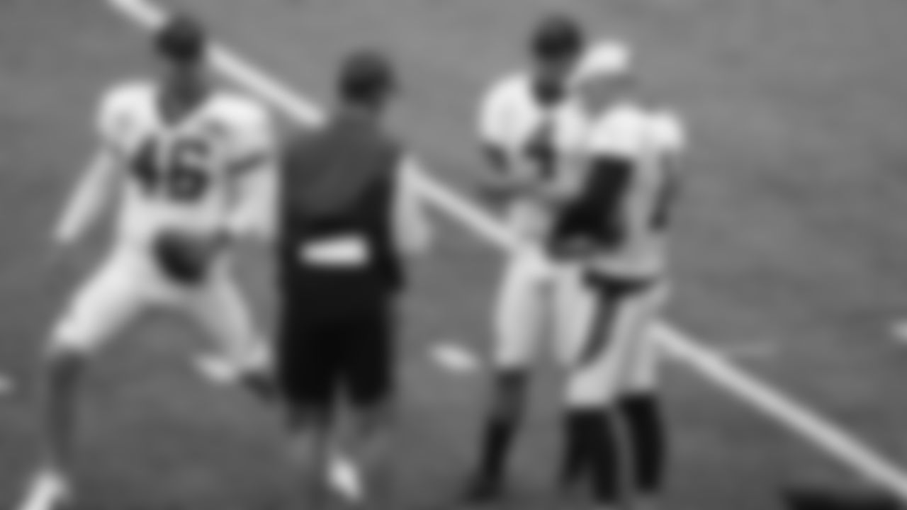 Cincinnati Bengals long snapper Clark Harris (46), place kicker Randy Bullock (4), and punter Kevin Huber (10) meet with a member of the coaching staff before an NFL football team scrimmage in Cincinnati, Sunday, Aug. 30, 2020. (AP Photo/Bryan Woolston)