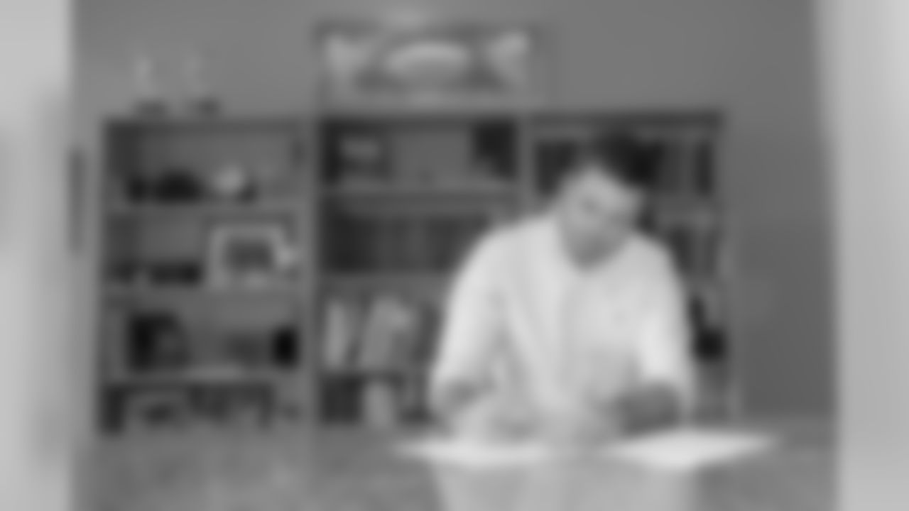 Zac Taylor signs his contract to become the 10th head coach in franchise history.