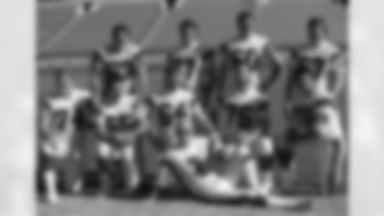 Cincinnati Bengals quarterback Boomer Esiason (7) poses with the Bengals' offensive line in Miami as they turn out for Super Bowl Media Day on Tuesday, Jan. 17, 1989. From left, back row: Joe Walter (63), Herb Wester (77), Dave Smith (60), David Douglas (67). Front: Brian Blados (74), Max Montoya (65), Bruce Kozerski (64), Bruce Reimers (75), Anthony Munoz (78). (AP Photo/Al Behrman)