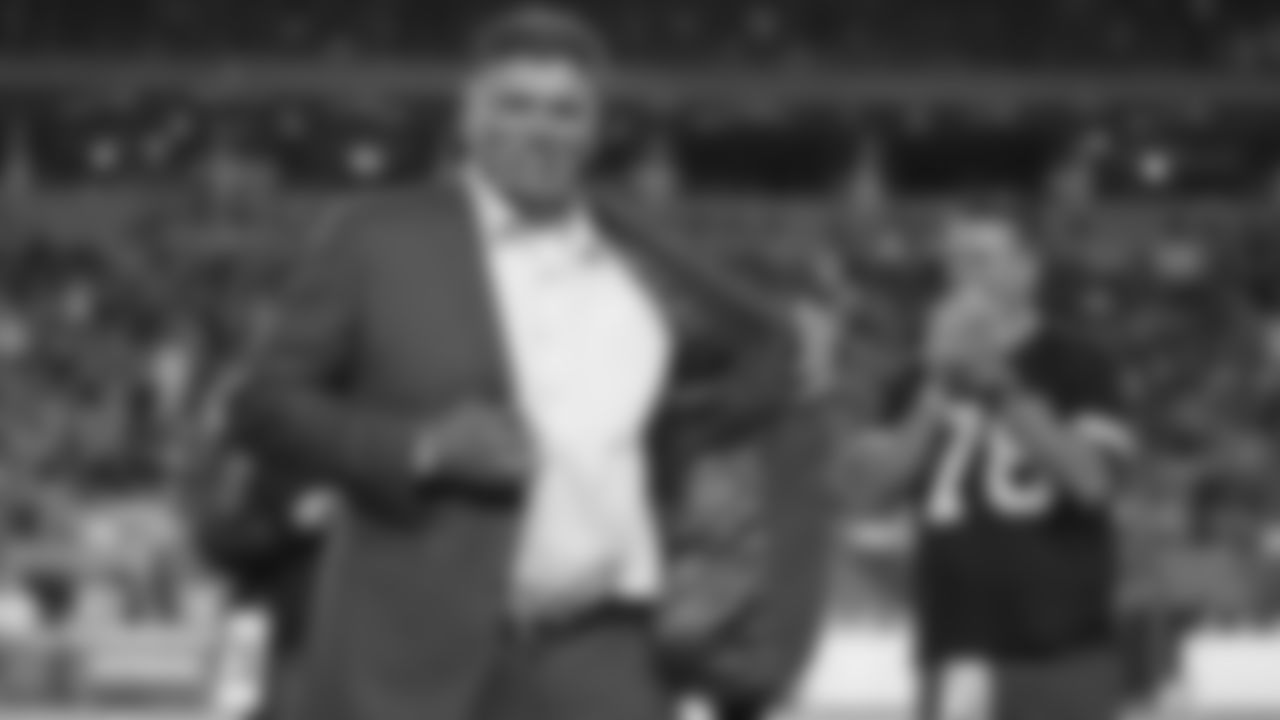 Former Cincinnati Bengals' Anthony Munoz holds open his jacket during a "Ring of Honor" ceremony during an NFL football game between the Cincinnati Bengals and the Jacksonville Jaguars, Thursday, Sept. 30, 2021, in Cincinnati. (AP Photo/Michael Conroy)