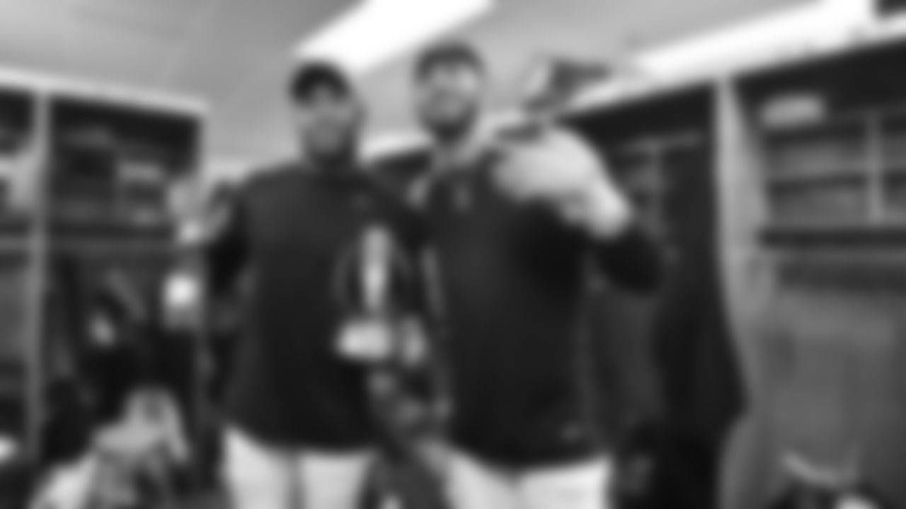 Vonn Bell (left) and Jessie Bates III (right) celebrate with the AFC Championship trophy.
