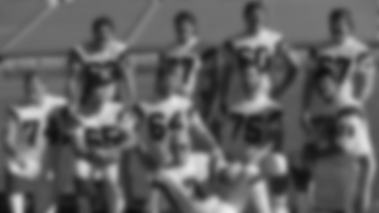 1989: Cincinnati Bengals quarterback Boomer Esiason (7) poses with the Bengals' offensive line in Miami as they turn out for Super Bowl Media Day on Tuesday, Jan. 17, 1989. From left, back row: Joe Walter (63), Herb Wester (77), Dave Smith (60), David Douglas (67). Front: Brian Blados (74), Max Montoya (65), Bruce Kozerski (64), Bruce Reimers (75), Anthony Munoz (78).