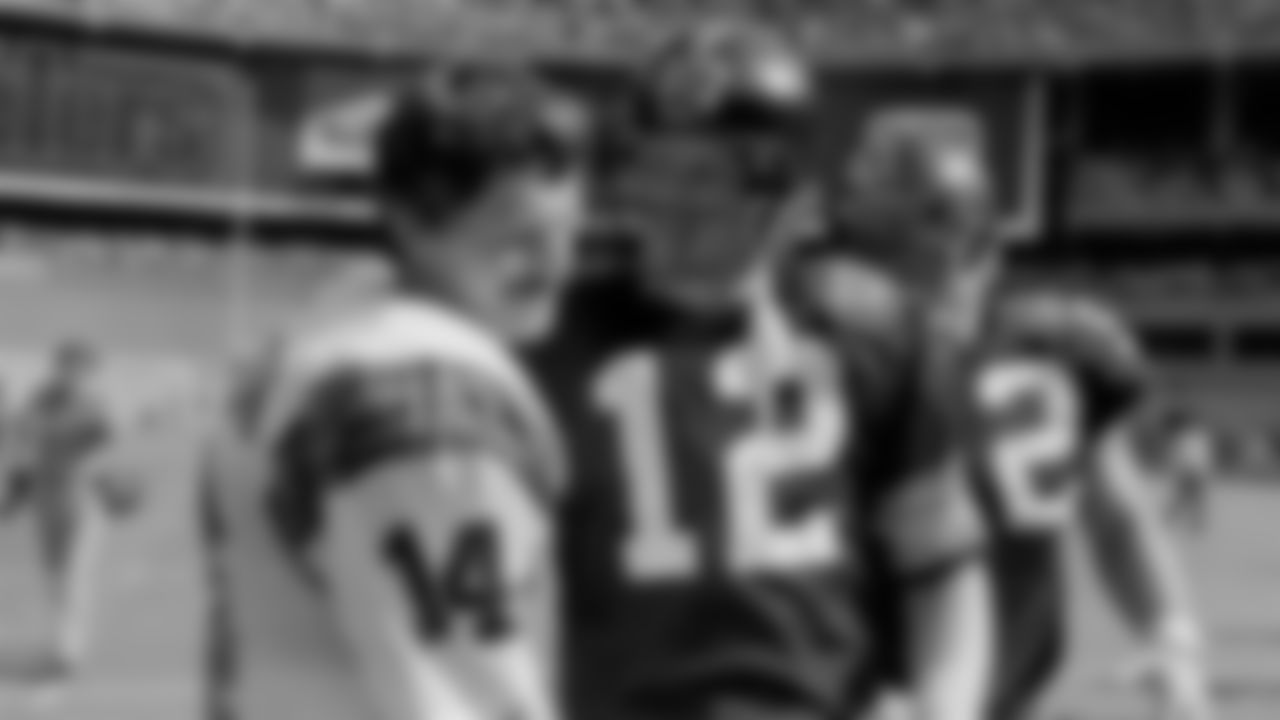 Cincinnati Bengals quarterback Ken Anderson (14) meets with Pittsburgh Steelers quarterback Terry Bradshaw after the Steelers won 26-20 overtime game in Pittsburgh on Sept. 19, 1982. After Anderson tossed interception, Bradshaw connected on game-winning pass on next play. (AP Photo/Gene Puskar)
