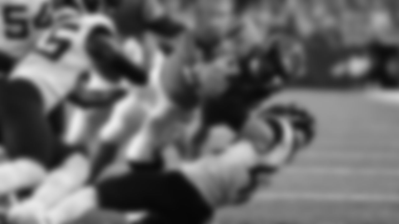 Running back Joe Mixon plows through Jaguars defenders for a one-yard rushing touchdown against the Jacksonville Jaguars.