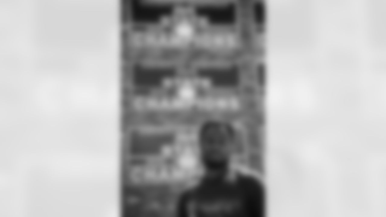 Isaiah McKenzie poses for a photo in front of his State Championship banner at his old high school during the 2022 off-season in Miami, Florida. Photo by Ben Green