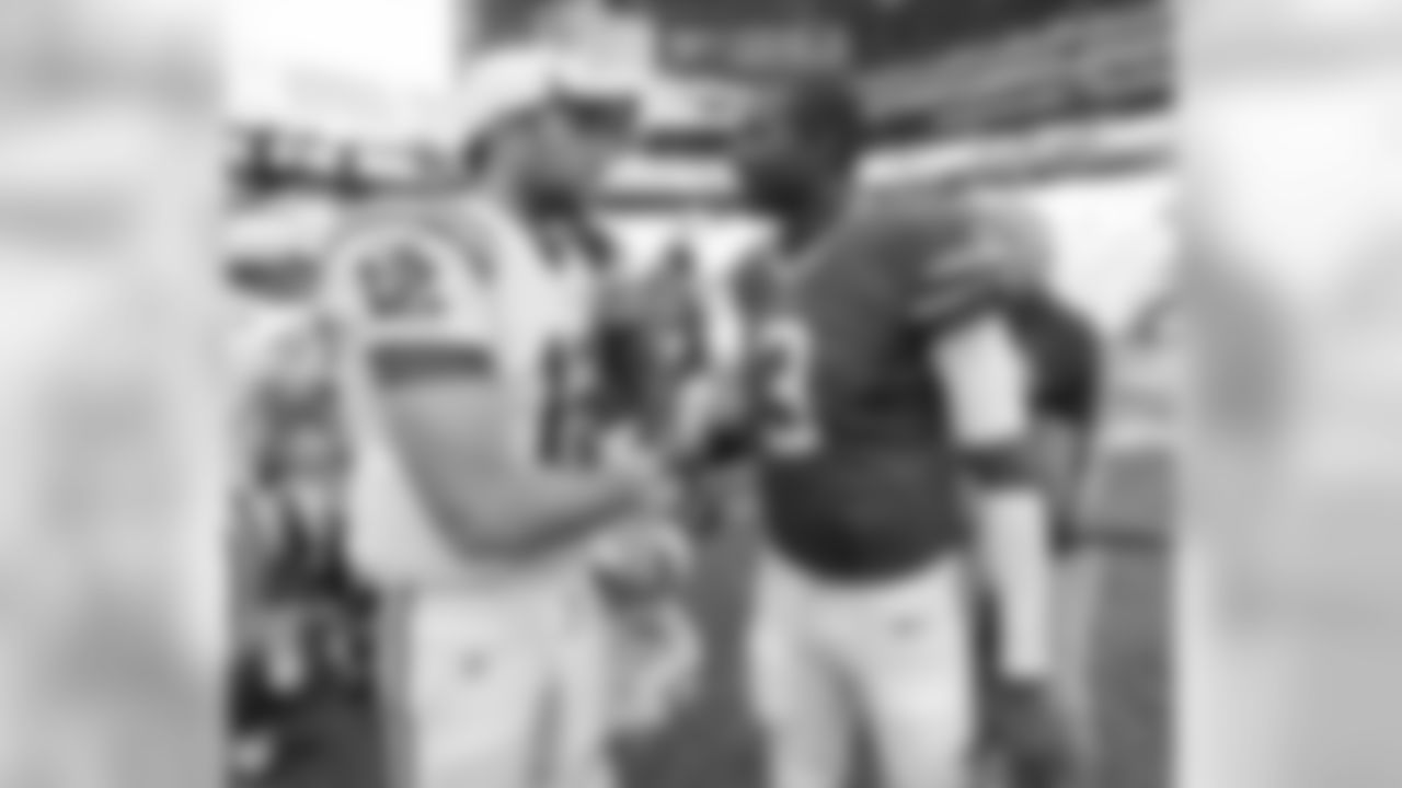 Indianapolis Colts' Andrew Luck (12) talks with Buffalo Bills' EJ Manuel following an NFL preseason football game on Sunday, Aug. 11, 2013, in Indianapolis. Buffalo defeated Indianapolis 44-20. (AP Photo/Michael Conroy)