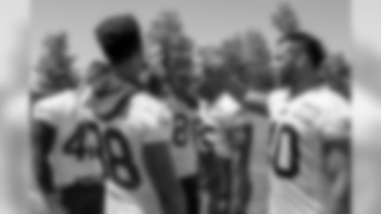 A group of Bills players including, running backs LeSean McCoy, Jonathan Williams and James Wilder, Jr, huddle together during Week 2 of OTAs.