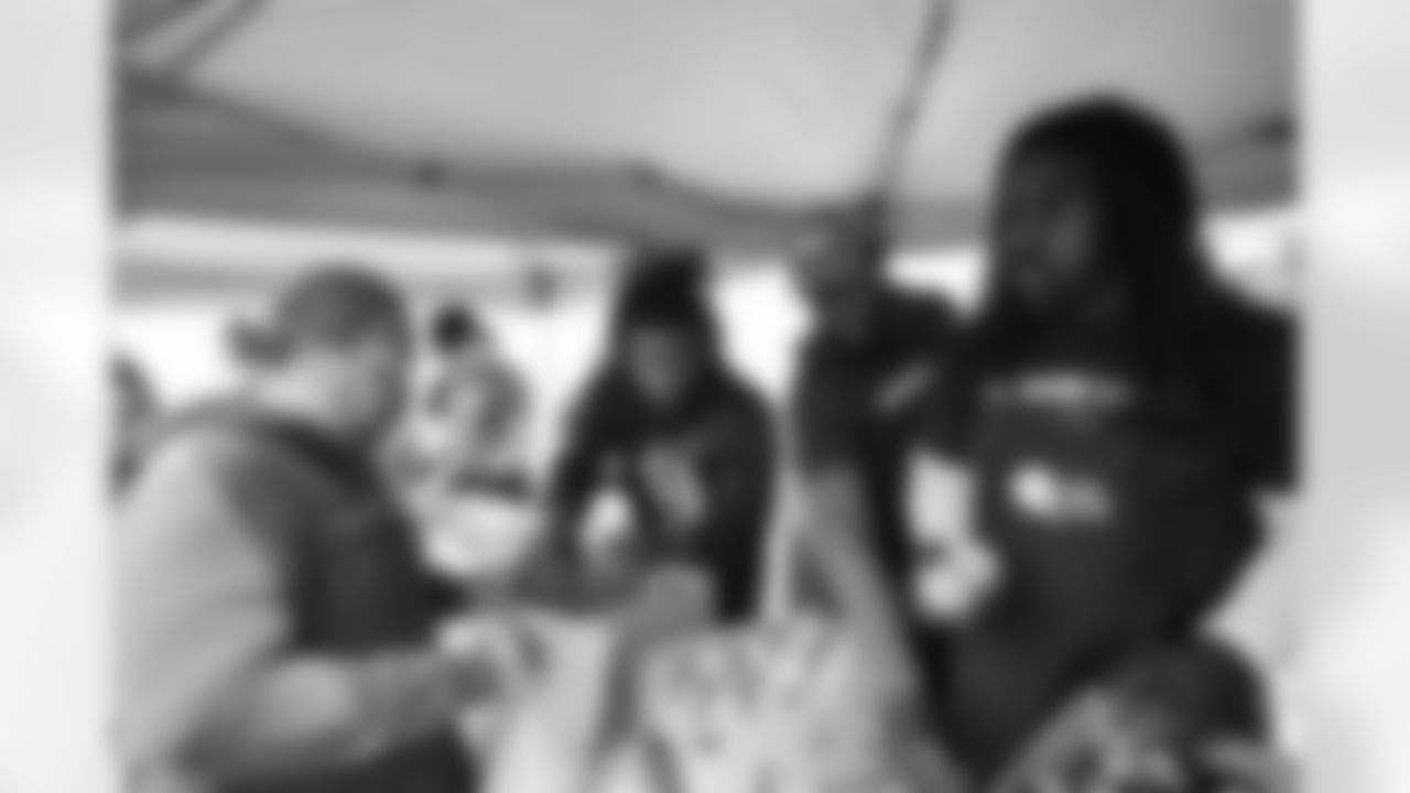 Josh Thomas (36) and Brandin Bryant (93). Players and staff from the Buffalo Bills, Bandits, and Sabres handed out food to the community in partnership with World Central Kitchen and chef Darian Bryan on May 18, 2022. Photo by Ben Green
