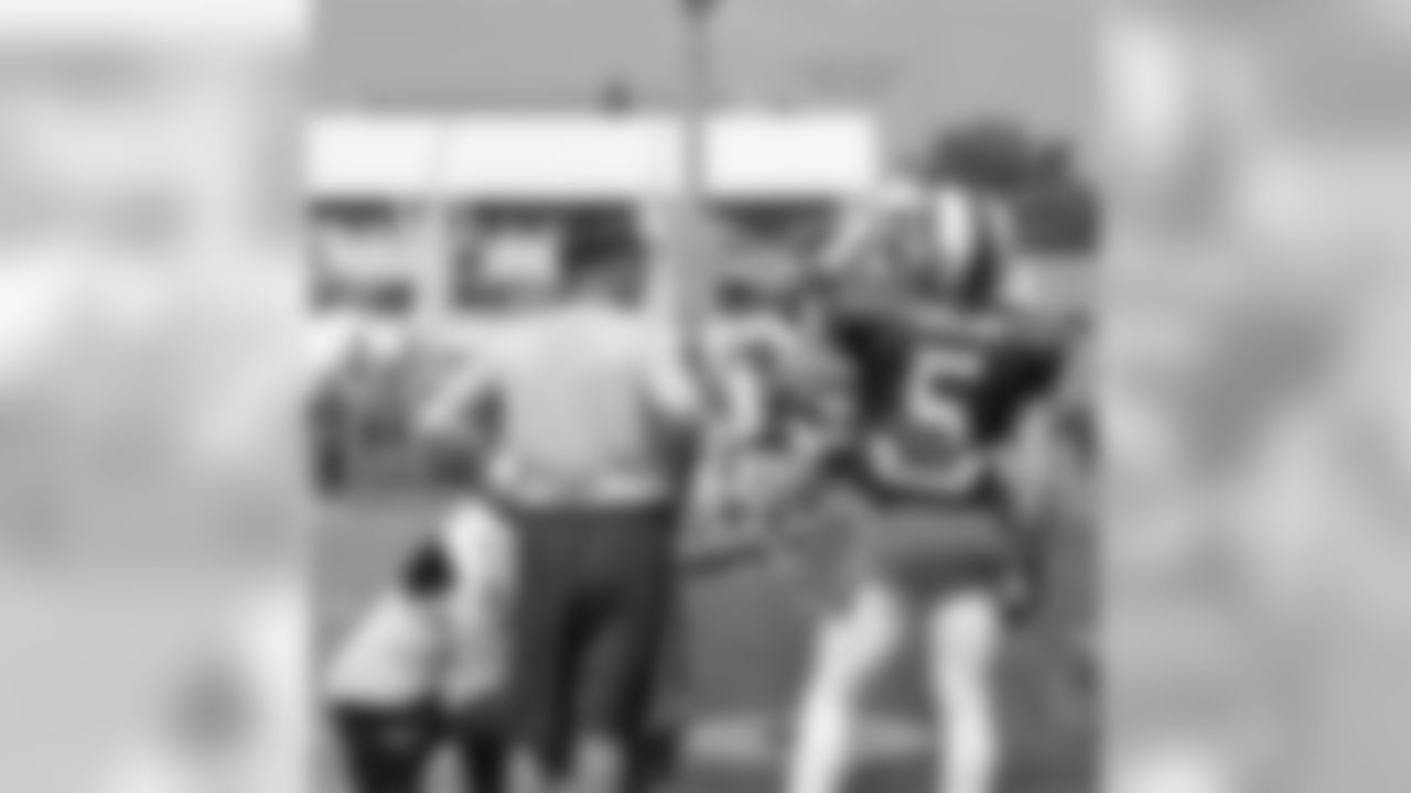 Quarterback coach David Lee with QB Tyrod Taylor (5) on the field.