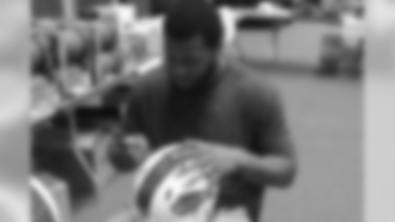 Tight end Charles Clay signs a helmet at Media Day 2016.