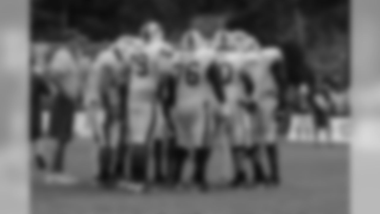 An offensive huddle on the field.