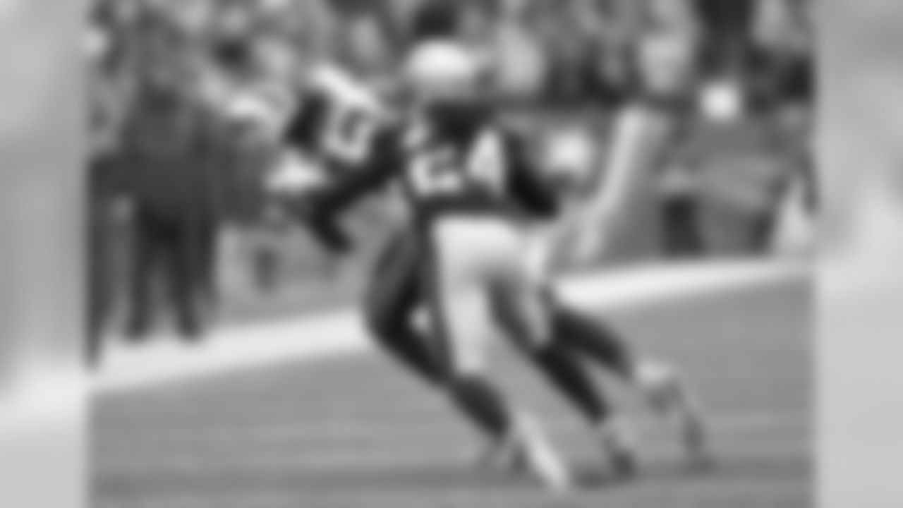 WR Kelvin Benjamin (No. 13) hauls in a pass in front of a Patriots defender