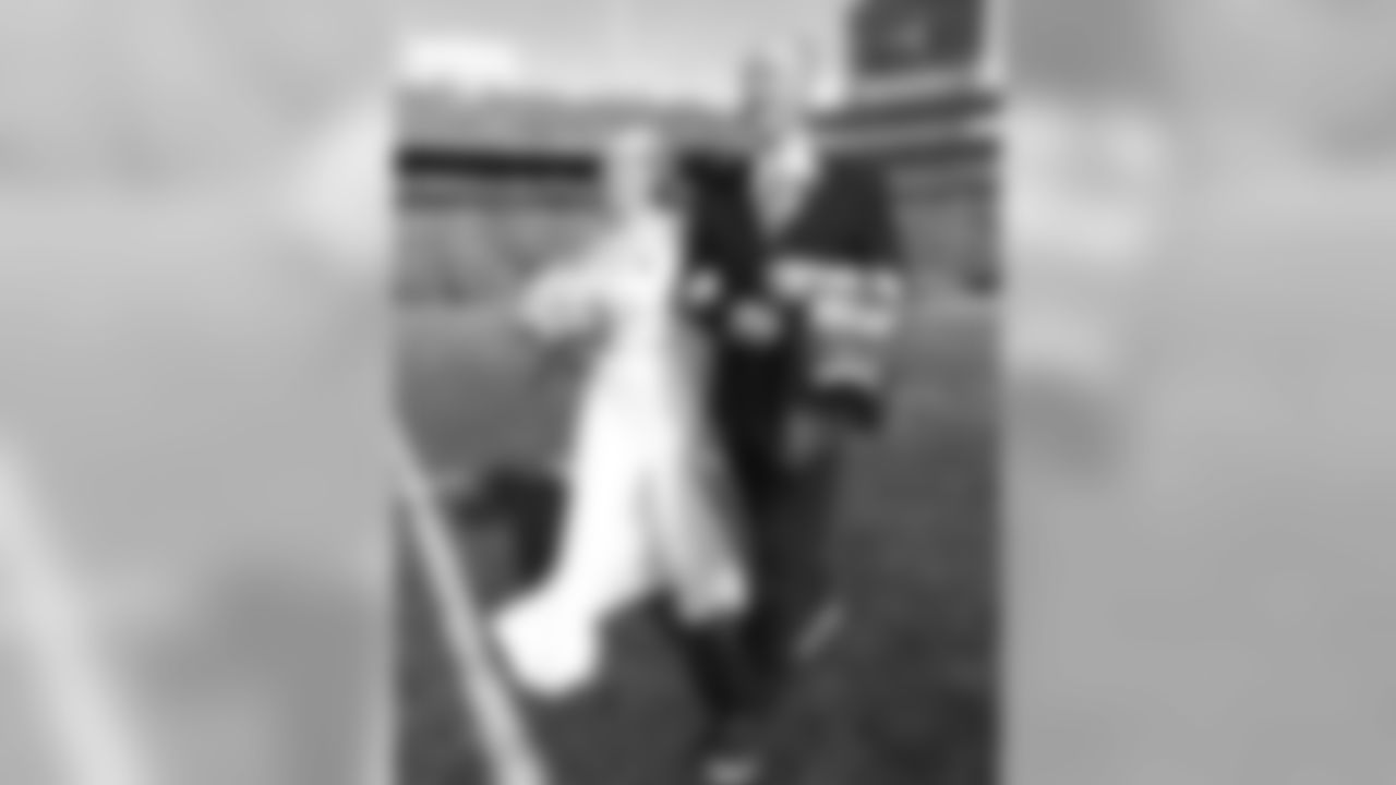 The Buffalo Bills celebrate the marriage of Mackenzie Park and Jordan Binggeli, the winning couple from the ÒHalftime Wedding Experience of a LifetimeÓ contest, at New Era Field on September 29, 2019.