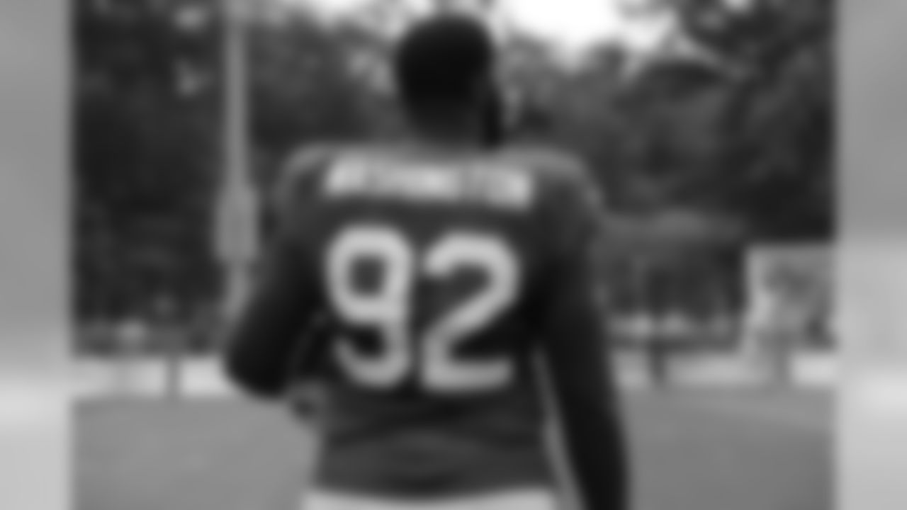 Defensive tackle Adolphus Washington (92) looks onto practice.