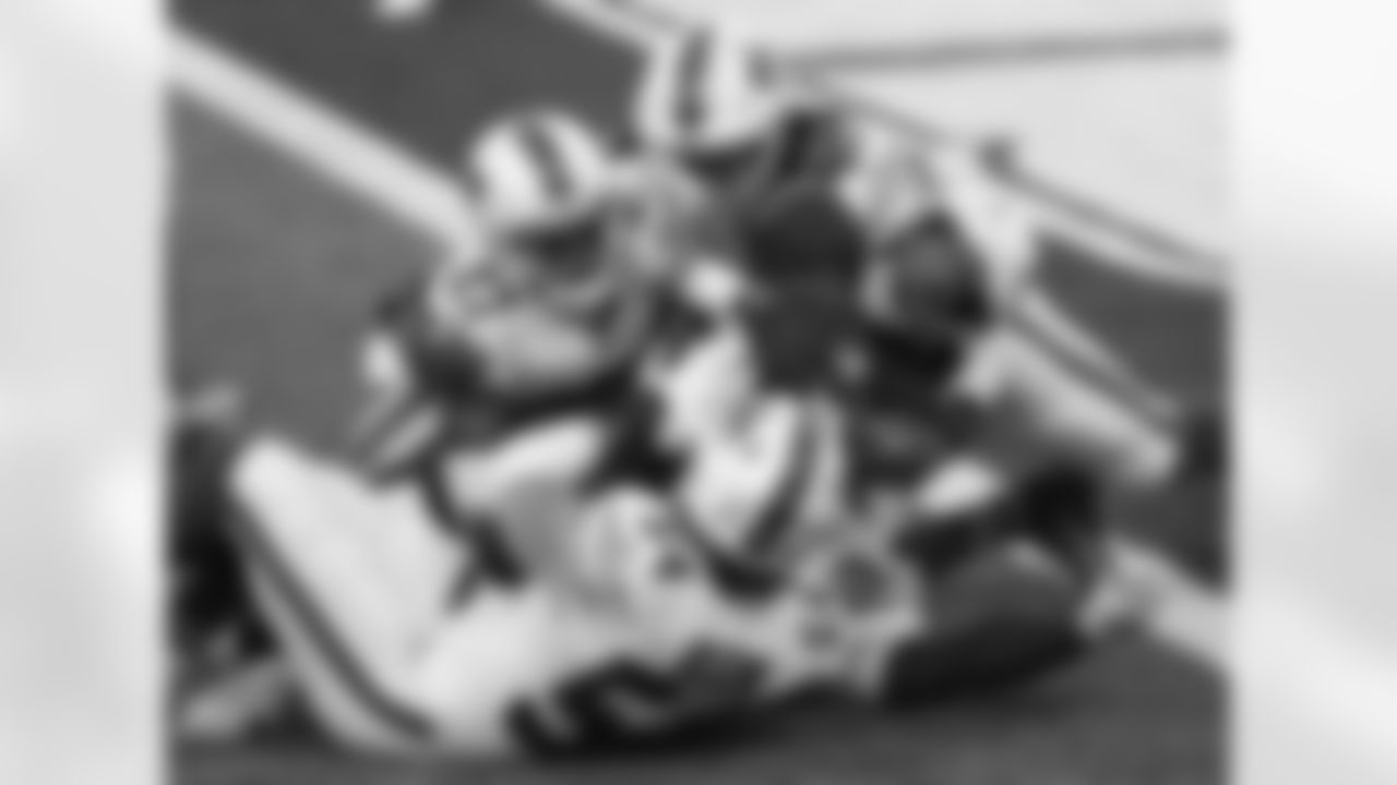 A.J. Klein (54) Tre'Davious White (27) and Tremaine Edmunds (49) stop the run. Buffalo Bills vs Los Angeles Chargers, November 29, 2020 at Bills Stadium.
Photo by Sara Schmidle