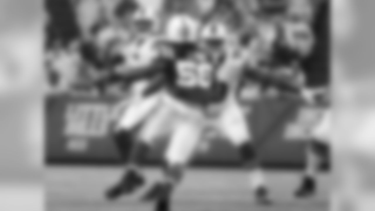 Defensive tackle Marcell Dareus (99) blocks for quarterback Tyrod Taylor (5).