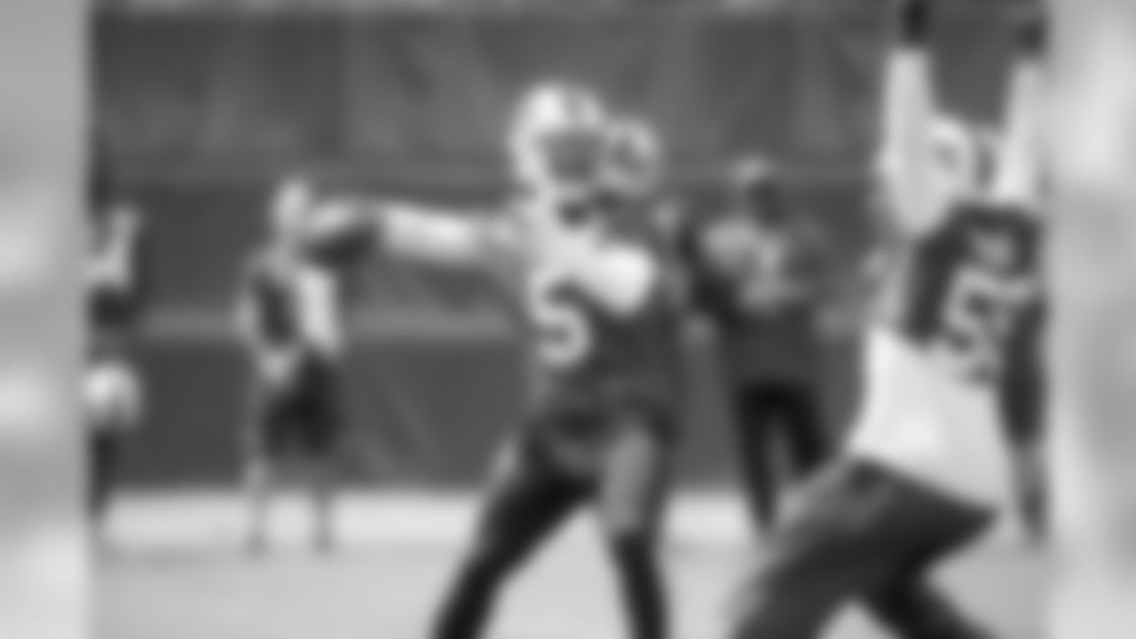 Bills quarterback Tyrod Taylor in action during Week 2 of OTAs, as defensive end Jerry Hughes pursues him.