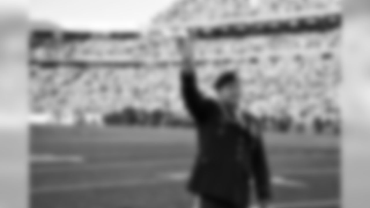 A member of the United States military waves to the crowd at Ralph Wilson Stadium, on Salute to Service gameday 2015.