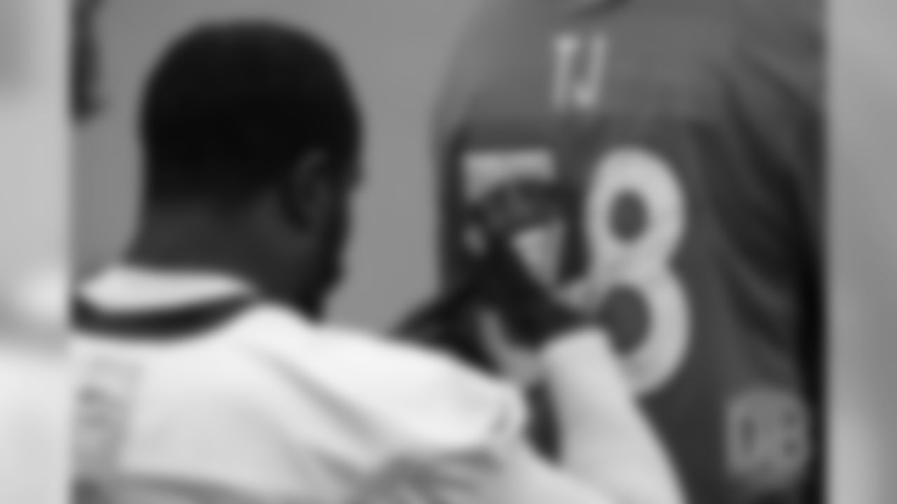 TJ, a 12-year-old fighting cystic fibrosis, wanted to be Von Miller for a day, and the Make-A-Wish Foundation helped make that dream come true on September 29, 2018. Here, Miller autographs and writes a note on his jersey.