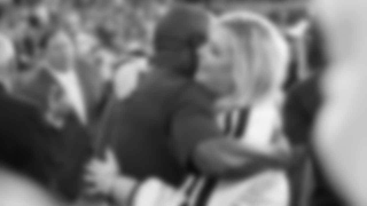 Champ Bailey hugs Amie Klemmer before the Broncos' preseason matchup with the Falcons in the Pro Football Hall of Fame Game on August 1, 2019 at Tom Benson Hall of Fame Stadium.