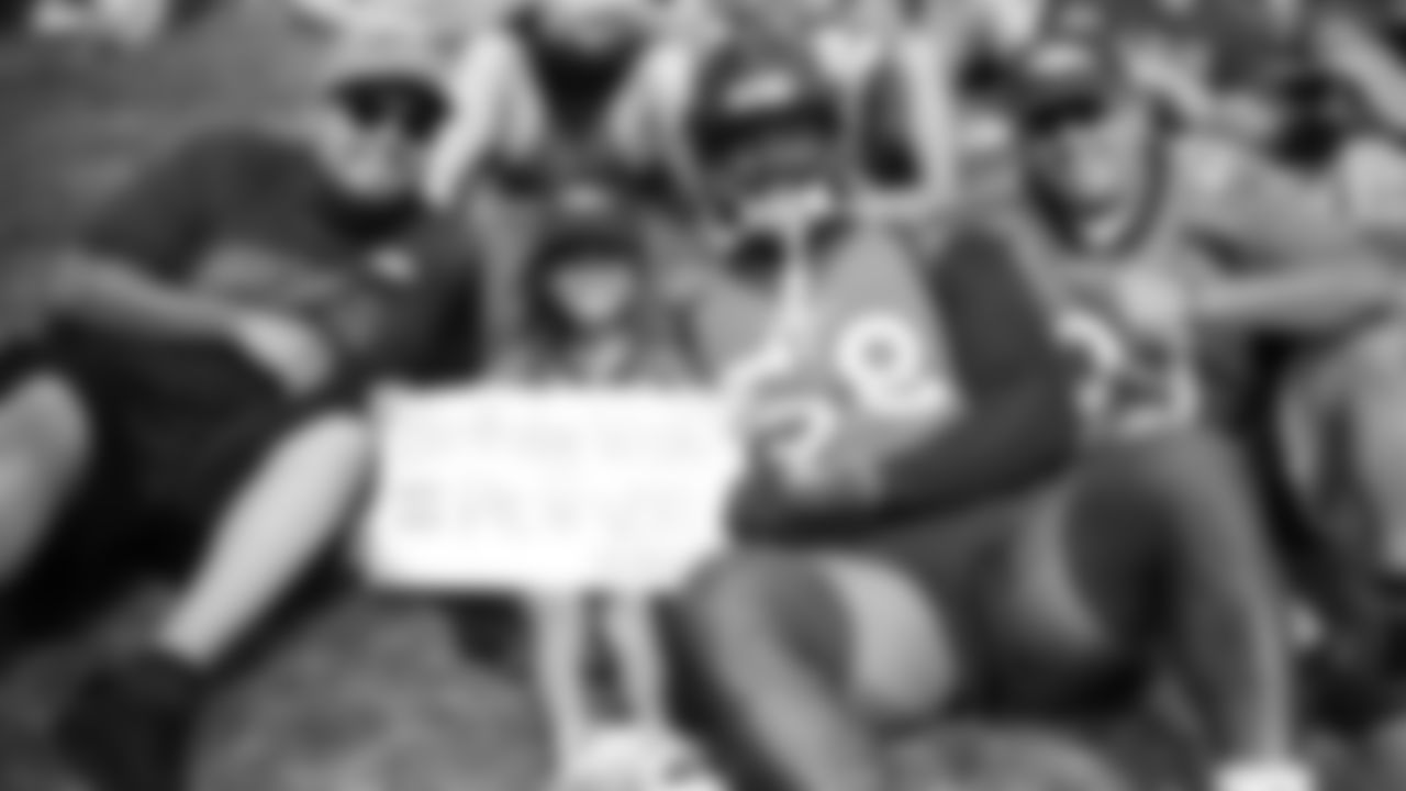Von Miller poses for a photo with a young fan on her birthday during practice on Day 11 of training camp on July 30, 2019.