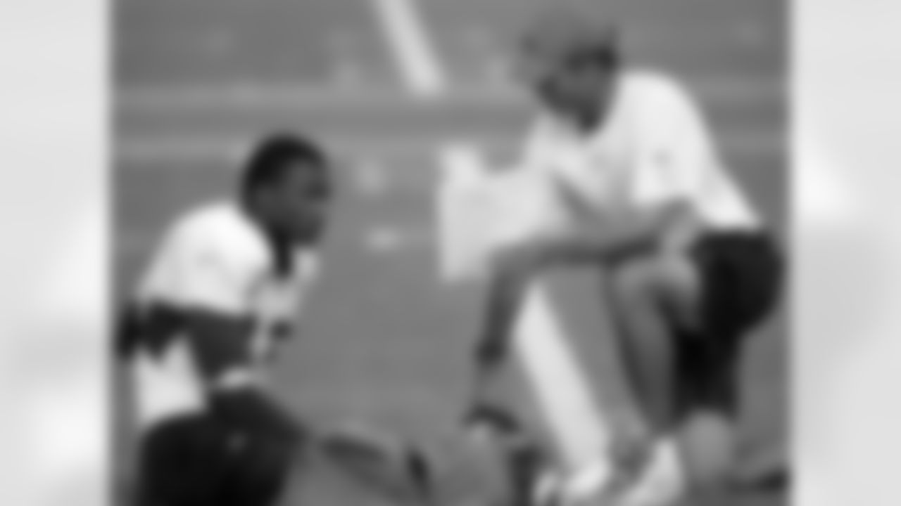 Denver Broncos wide receiver coach Steve Watson talks with rookie wide receiver Brandon Marshall during the morning football training camp session at the Broncos' headquarters in Denver, Thursday, Aug. 3, 2006. (AP Photo/Jack Dempsey)